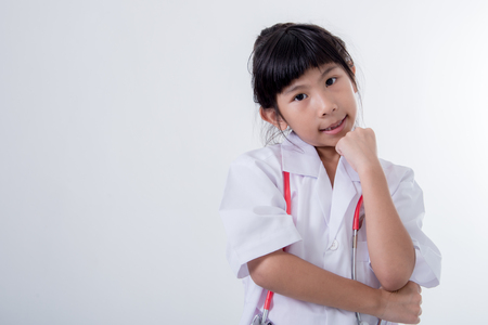 Little girl pretending to be a doctor on white backgroundの写真素材