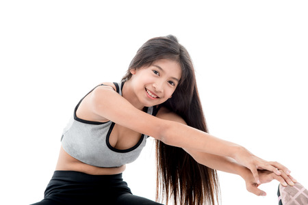 Asian teenager doing stretching exercise on white.の写真素材