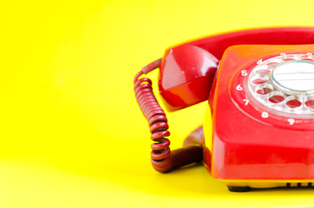 Retro Red Telephone on yellow Backgroundの写真素材