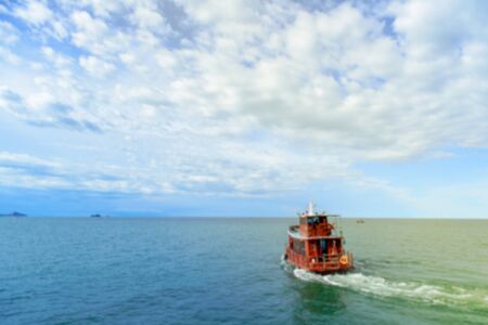 Blurry background  boat floating on the water, blue sea and sky with copyspaceの写真素材