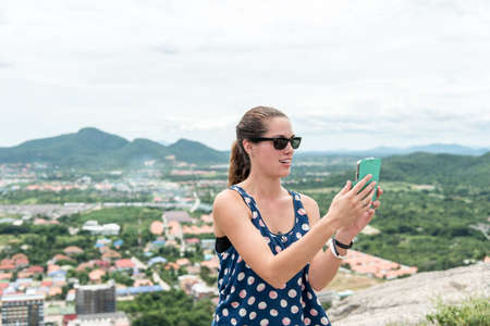 Young woman selfie on the beautiful nature view in mountains.の写真素材