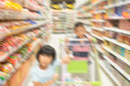 Blurry background children shopping at supermarket.の写真素材