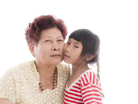 Grandmother holding granddaughter with loveの写真素材