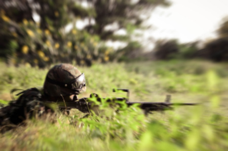 Blurry background soldier maneuver with machine gunの写真素材