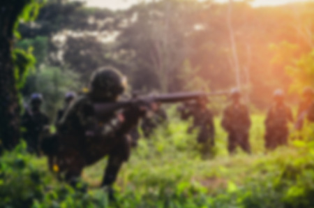 Blurry background soldier maneuver with machine gun