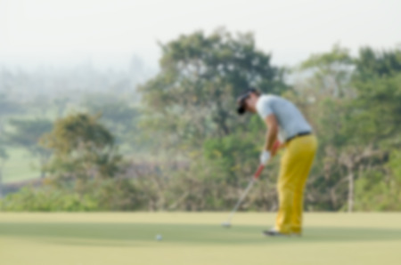 Blurry background man playing golfの写真素材