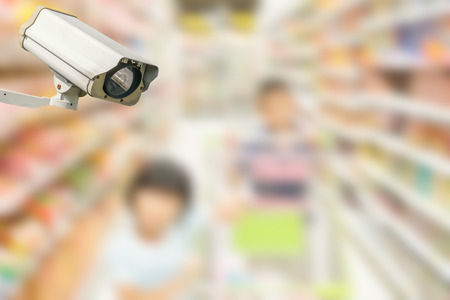 Modern security camera on monitoring the supermarket with blurred backgroundの写真素材