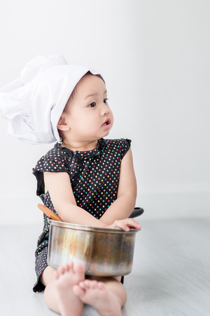 Asian child playing a chef at home.の写真素材