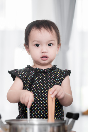 Asian child playing a chef at home.の写真素材