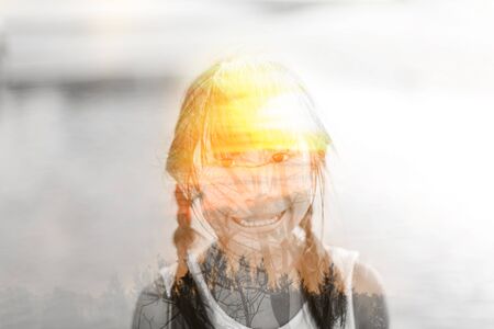 Creative double exposure portrait of Asian girl  with sun light.