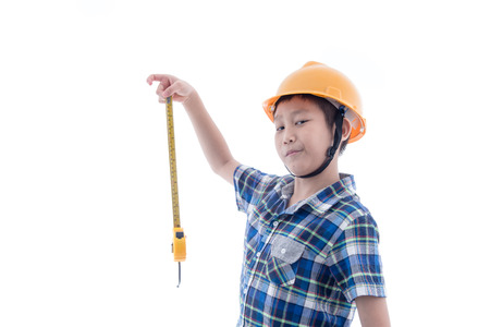 Asian boy dressed like worker holding measuring tape on white.の写真素材
