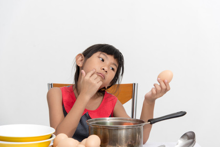 Asian child playing a chef at home.の写真素材
