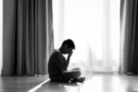 Blurry background Silhouette sad boy crying at window, black and white.の写真素材