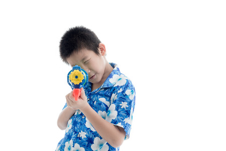 Young Asian boy with water gunの写真素材