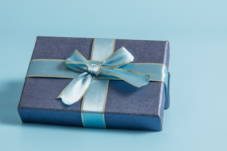 Blue gift box on blue colour backgroundの写真素材