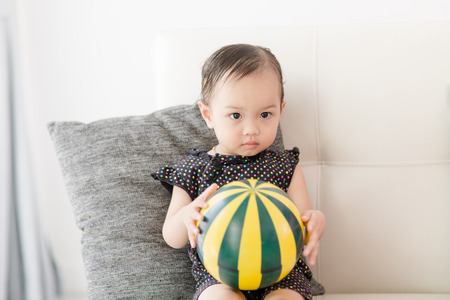 Closeup photo of beautiful cute asian baby's expression at home.  Selective focusの写真素材
