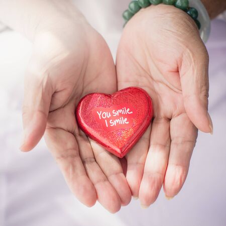 Red heart in senior's hands