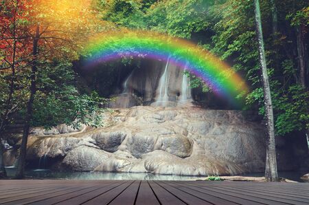 waterfall with rainbow and wooden floorの写真素材