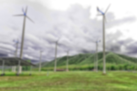 Blurry background green grass and turbine on farm on cloudy dayの写真素材