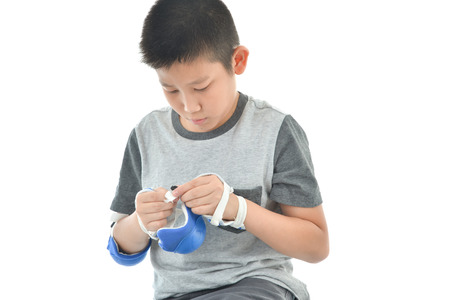Happy Asian boy wearinghand guard for playing roller blades on white.の写真素材