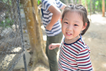 Happy Asian girl at the zoo outdoorの写真素材