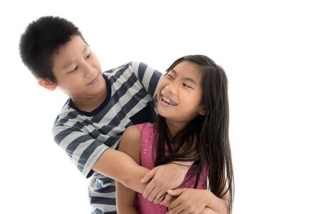 Sister and Brother against White Backgroundの写真素材