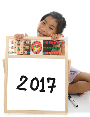 Asian child drawing 2017 on whiteboard on white background.