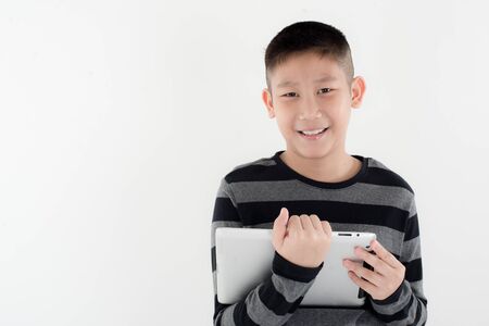 Boy looking at touch pad at home, copyspace for text
