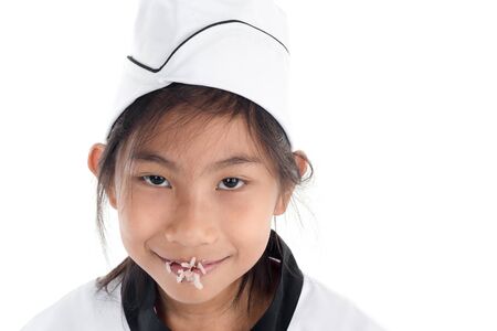 Asian young chef with sticky rice on her mouth, white background.の写真素材