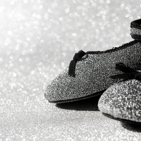 Black and white ballet shoes with glitter background.の写真素材