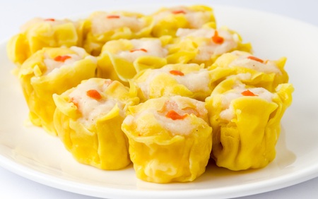 Chinese steamed shrimp dumplings on white dishの写真素材