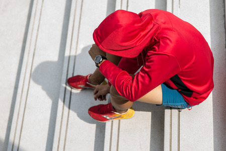 Young male jogger athlete training and doing workout outdoors in city.の写真素材