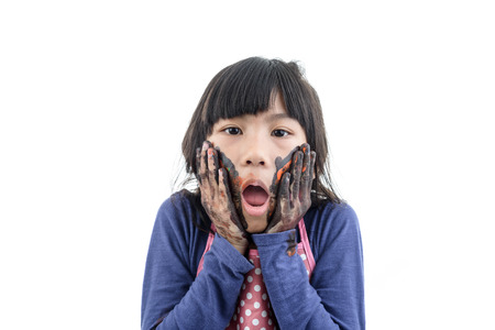 Close up Funny little girl with hands painted in colorful paint.の写真素材