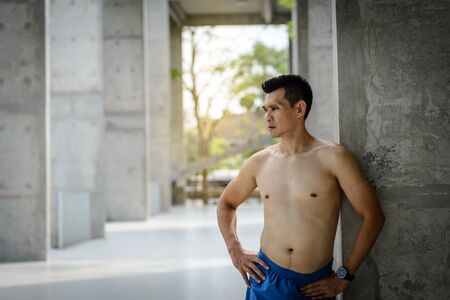 Sportman in boxer standing near building before exercise.の写真素材