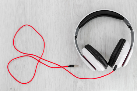 Headphone with red line in heart shape on gray background.の写真素材