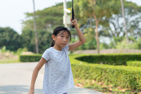 Asian girl playing badminton outdoor.の写真素材