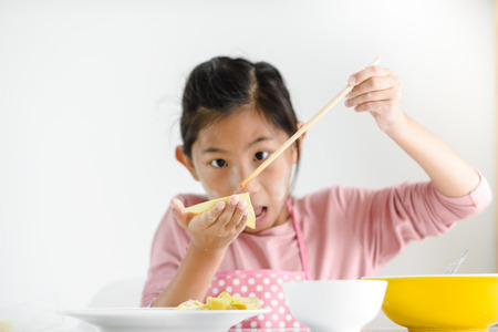 Girl holding homemade dumpling in her hand, lifestyle concept.の写真素材