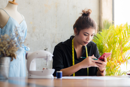 Asian freelance designer make a phone call, business lifestyle.の写真素材