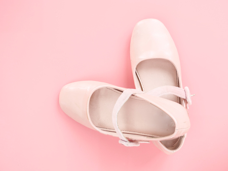 Pair of ballet shoes on pink background with copy space.の写真素材