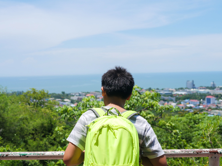 Backpack boy with city view of Hua Hin view point in sunny day.の写真素材