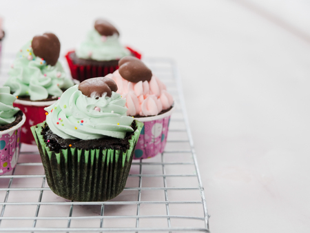 Green cupcakes on marble table, copy space.