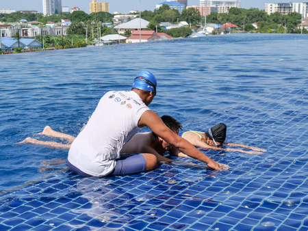 PRACHUBKIRIKHAN, THAILAND - OCTOBER 10, 2018:  Untitled swimming coach teaching his student for...