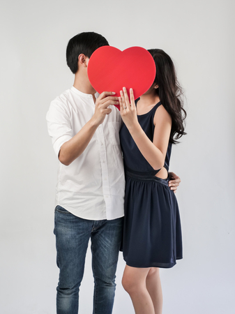 Happy couple in love holding red heart shape, valentine concept.の写真素材
