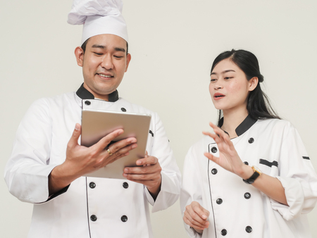 Happy Asian chef using tablet together, work lifestyle conceptの写真素材