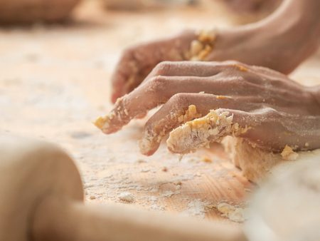 Motionblur chef hands preparing dough for pizza or bread on table closeupの写真素材