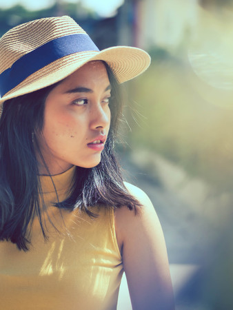 Happy Asian woman wearing sunglasses with sun light outdoor, lifestyle concept.  Reflection effect.