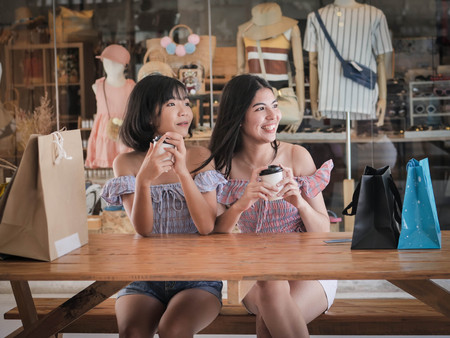 Happy shopper women sitting and break for drinking coffee, lifestyle concept.の写真素材