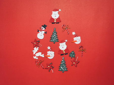 Christmas objects laid out in the shape of bubble on red background.の写真素材