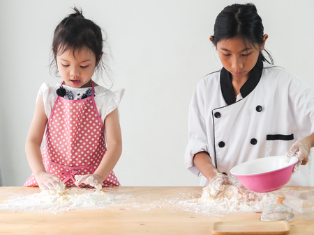Asian children learning how to baking pizza or bread, lifestyle concept.の写真素材