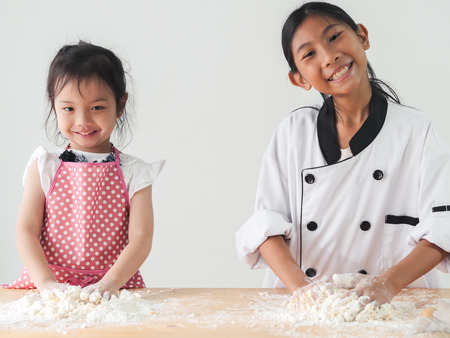 Asian children learning how to baking pizza or bread, lifestyle concept.